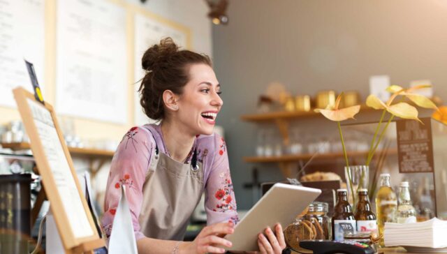oung woman using digital tablet in coffee shop