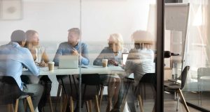 Business people negotiating at boardroom behind closed doors
