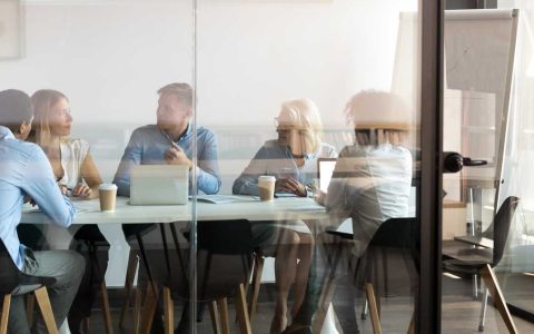 Business people negotiating at boardroom behind closed doors