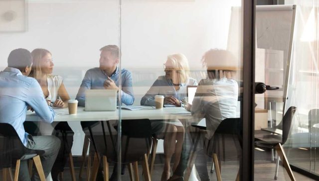 Business people negotiating at boardroom behind closed doors