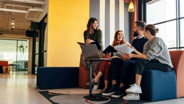 Multicultural businesspeople working in an office lobby